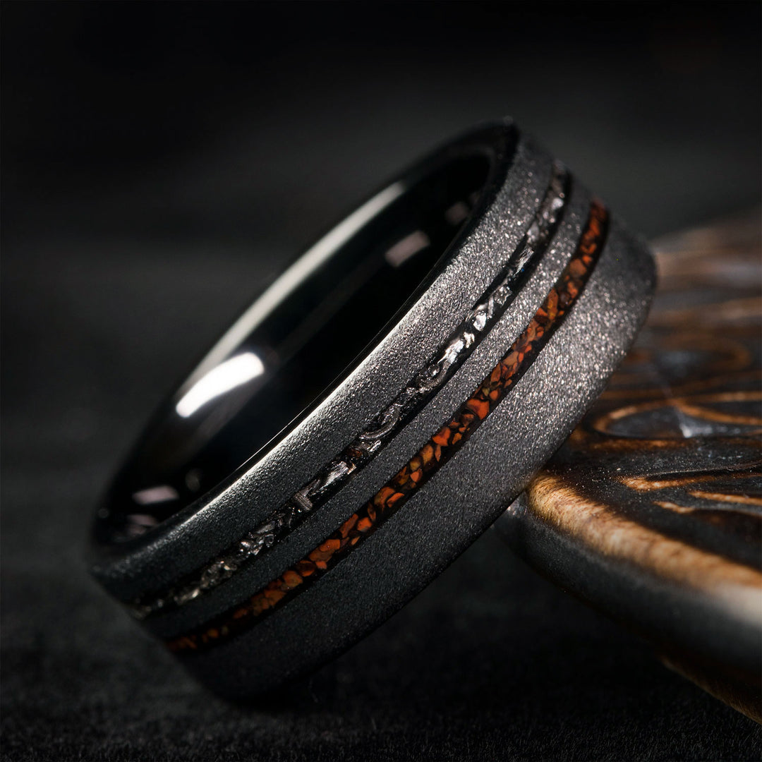 Black tungsten carbide wedding ring with dinosaur bone and meteorite inlay