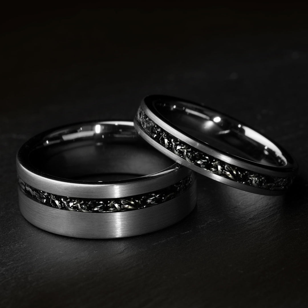 Brushed silver wedding rings with black meteorite inlay