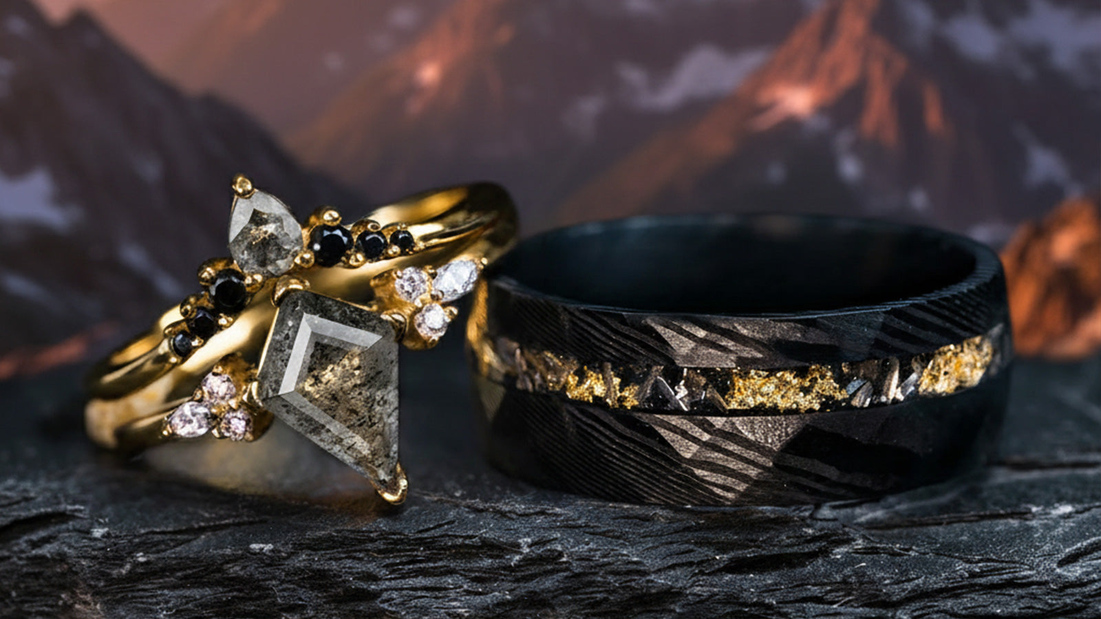 Complementary couple ring set featuring a vintage gold kite-cut salt and pepper diamond ring paired with a textured black Damascus steel band.