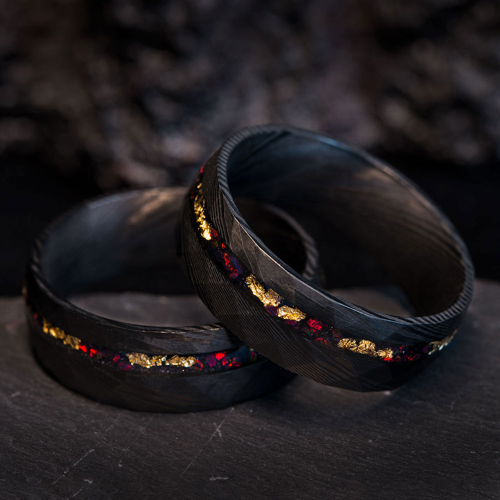 THE BRAVE FIRE hammered black Damascus steel wedding band with fire opal and 22k gold leaf inlay. Product page detail.