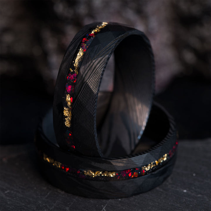Close-up of THE BRAVE FIRE ring, showcasing black Damascus steel, gold leaf, and fire opal