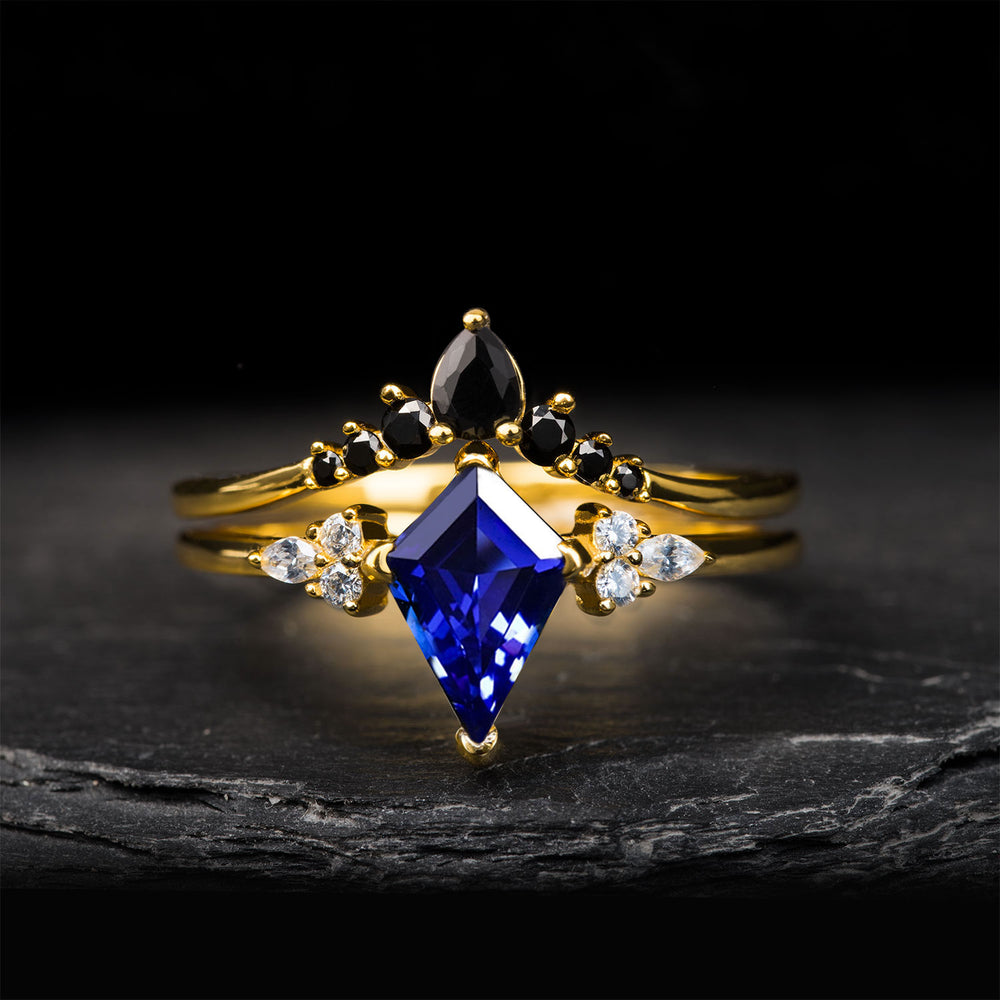 The Dark Moon set: men's black Damascus ring and women's gold ring set with blue gemstone.