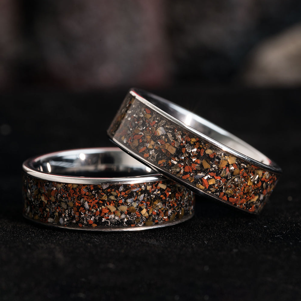 The Destroyer silver men's wedding ring with red dinosaur bone and meteorite dust inlay.
