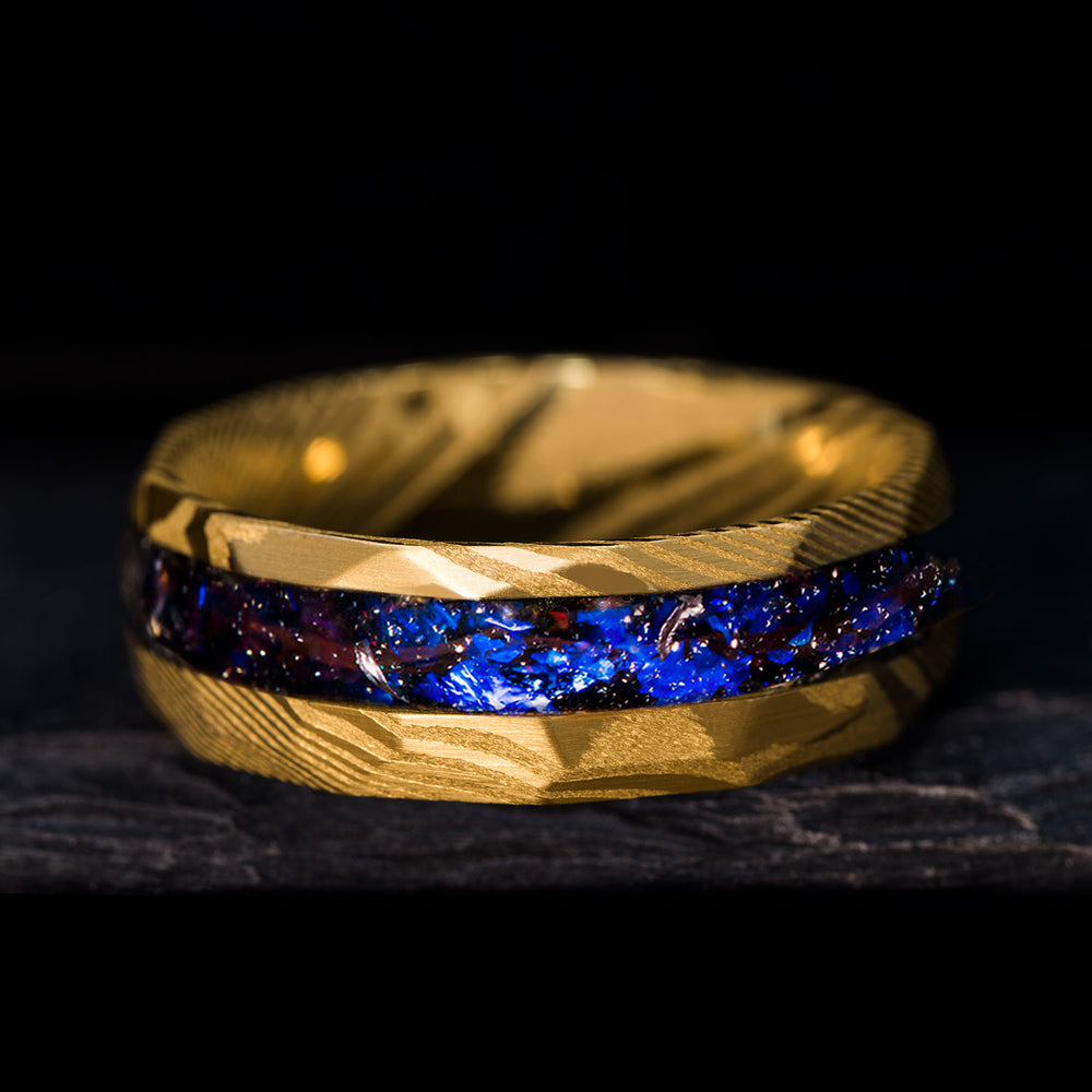 Hammered gold Damascus steel ring with blue alexandrite and meteorite inlay, unique wedding band.