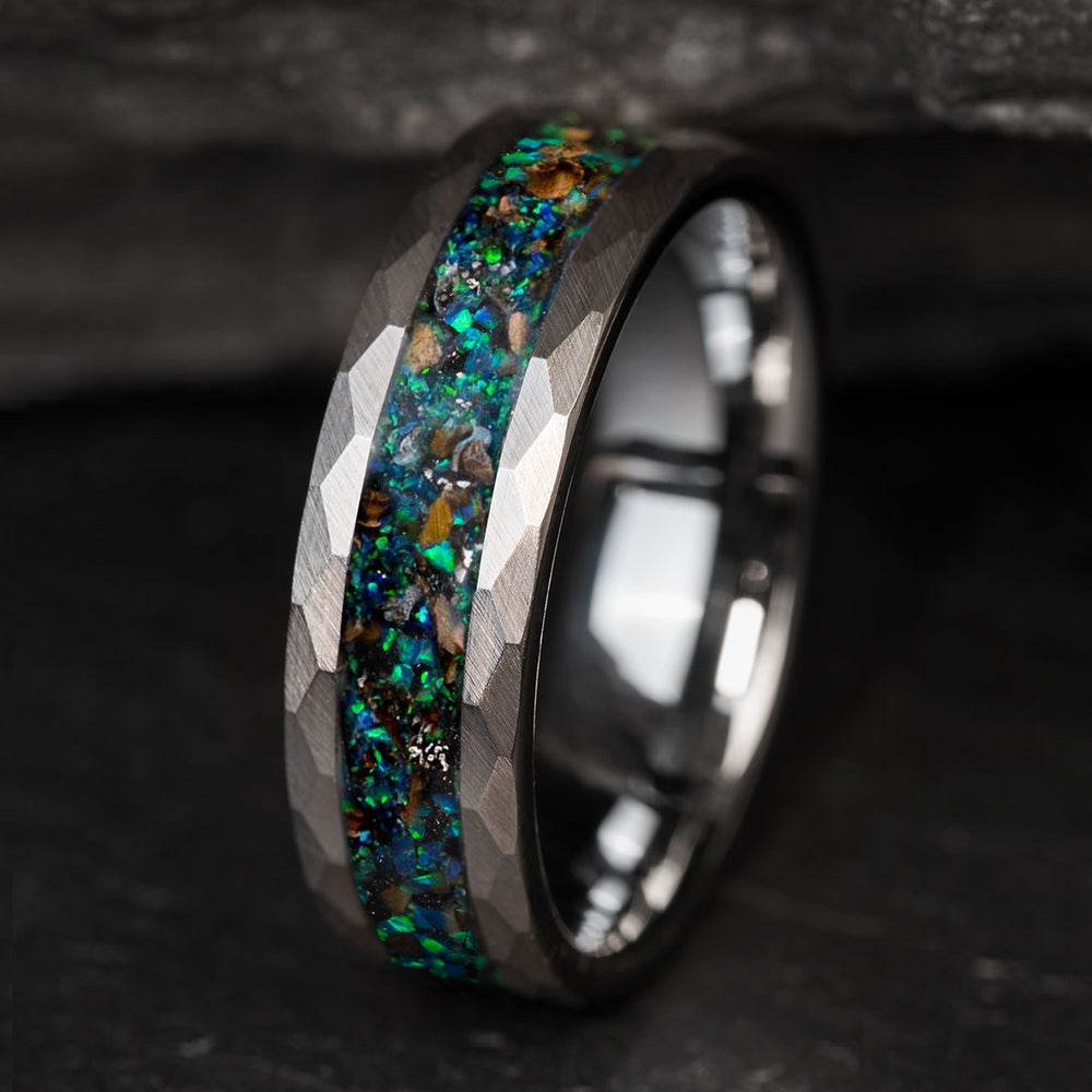 Hammered silver tungsten wedding band with blue-green opal, T. rex bone, and meteorite inlay.
