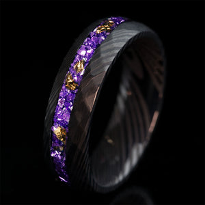 THE STORM FLAME wedding ring: black hammered Damascus steel with violet German glass and 22k gold leaf inlay.