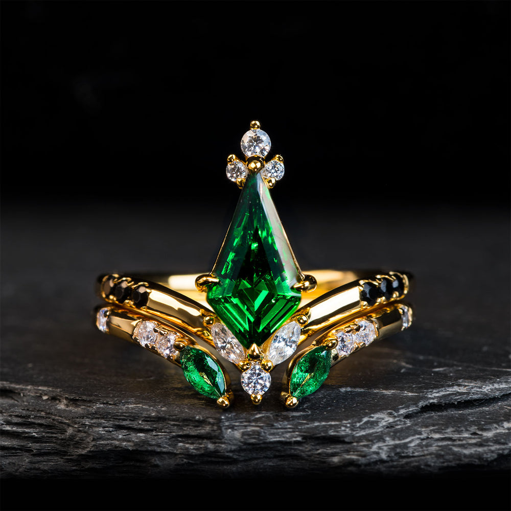The Venom wedding set: men's black tungsten, green opal; women's gold bands with kite emerald, diamonds, black zircons.