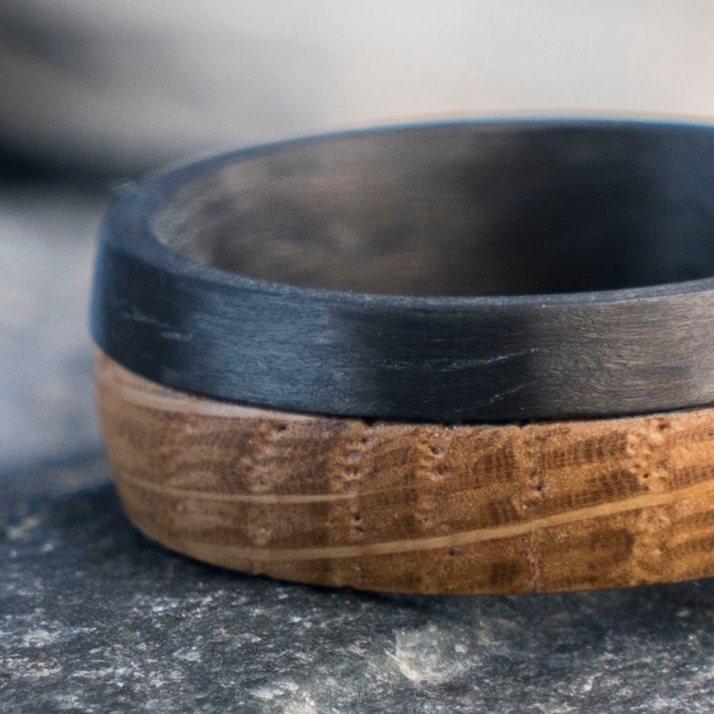 8mm men's carbon fiber ring with Macallan whiskey barrel wood inlay, showing rustic grain.