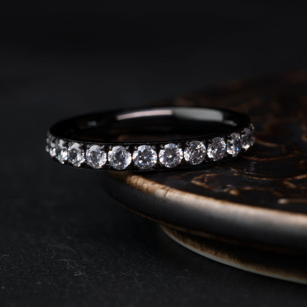 THE ANGEL women's black titanium 4mm band with channel-set cubic zirconia stones, product display.