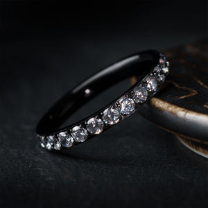 THE ANGEL women's black titanium wedding ring with channel-set cubic zirconia stones.