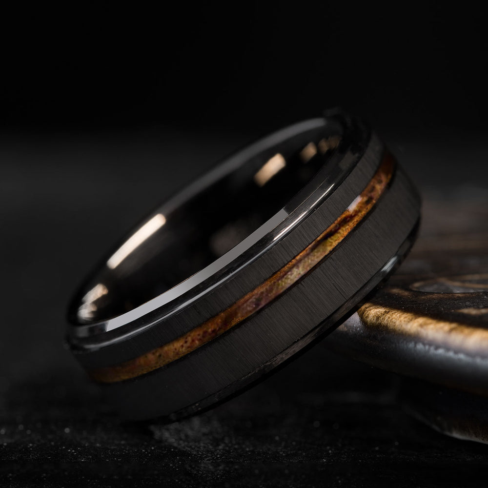 The Asura ring: black brushed tungsten carbide with beveled edges and Hawaiian Koa wood inlay.