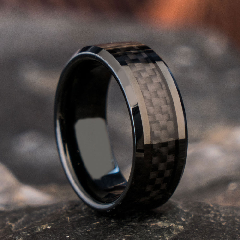 The Basalt black tungsten ring showcases a woven forged carbon fiber inlay, 8mm wide, perfect for modern wedding bands.