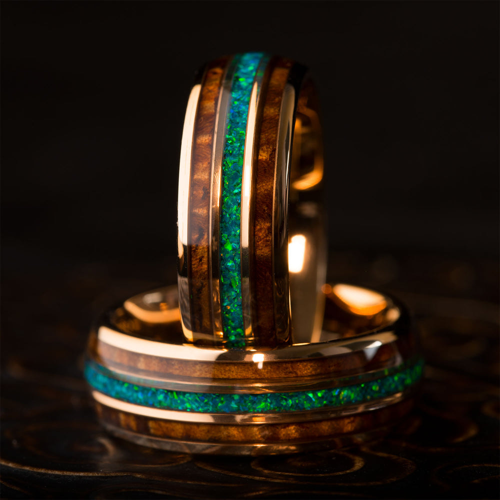Rose gold tungsten wedding band with koa wood and striking green-blue opal inlay, product page.