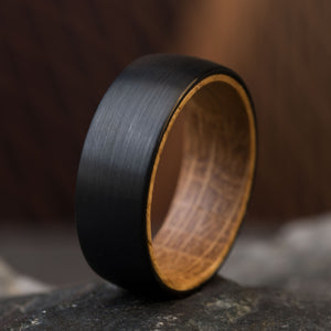 The Dark Knight: black tungsten wedding band with whiskey barrel wood interior, 8mm wide, comfort fit.