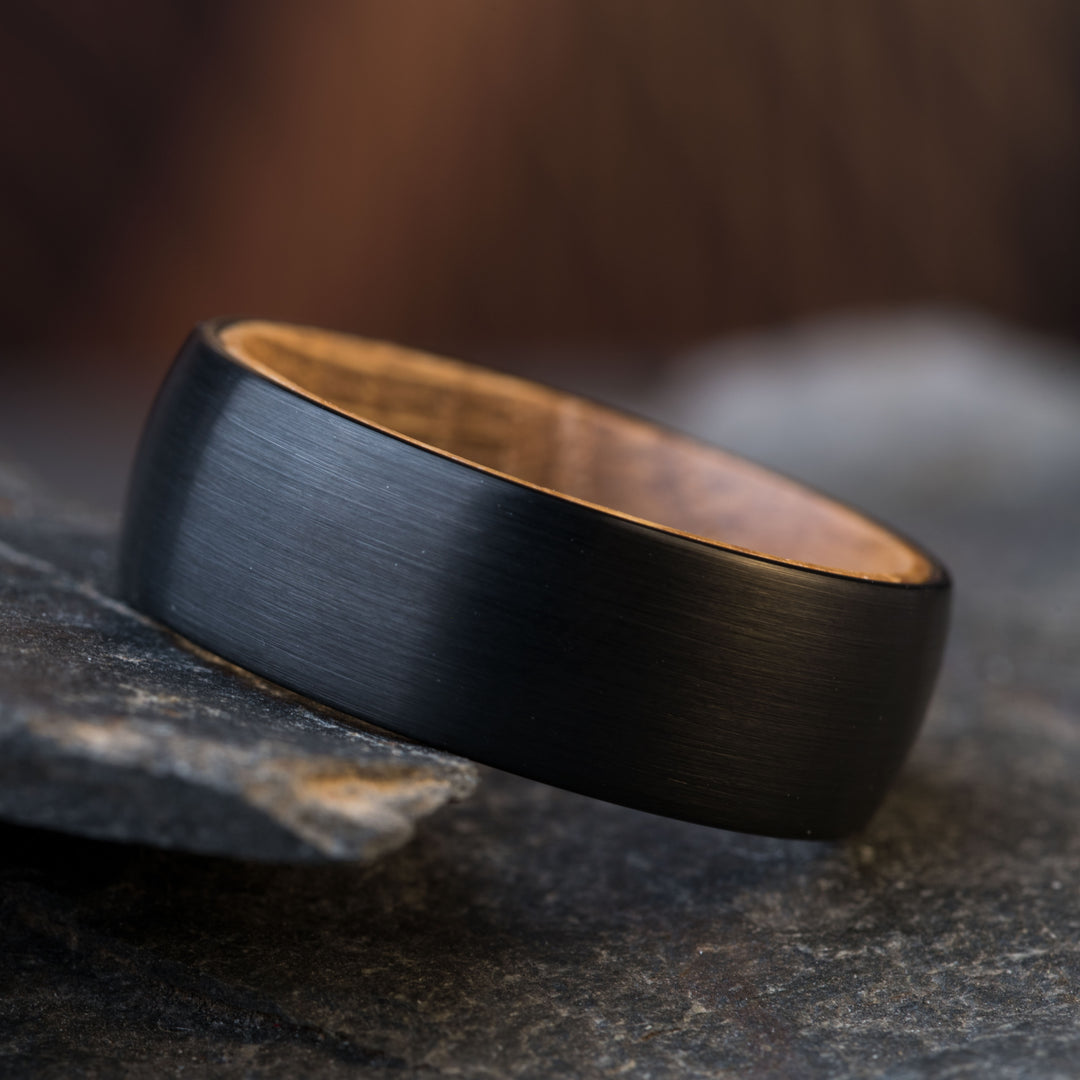 Black tungsten wedding ring with whiskey barrel wood inlay detail