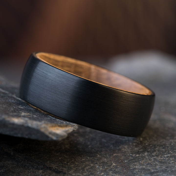 Black tungsten wedding ring with whiskey barrel wood inlay detail