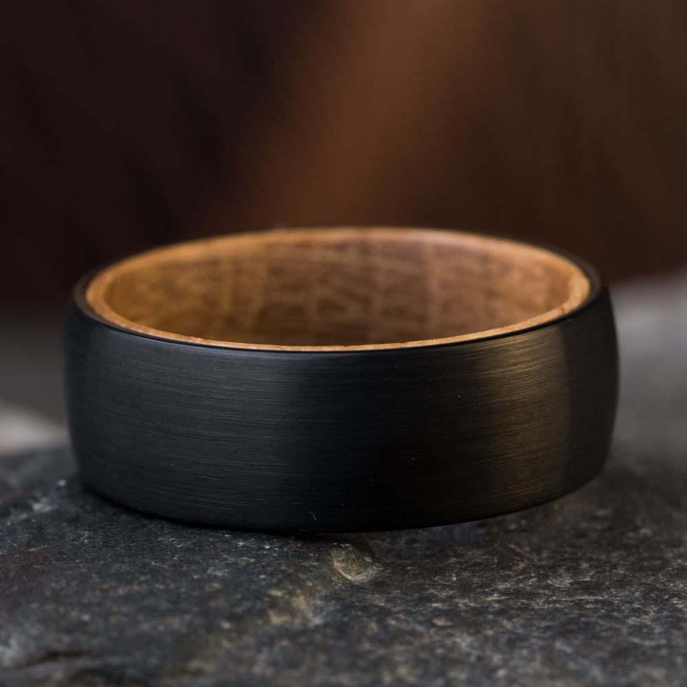 Black tungsten dome ring with whiskey barrel wood interior, 8mm comfort fit wedding band.