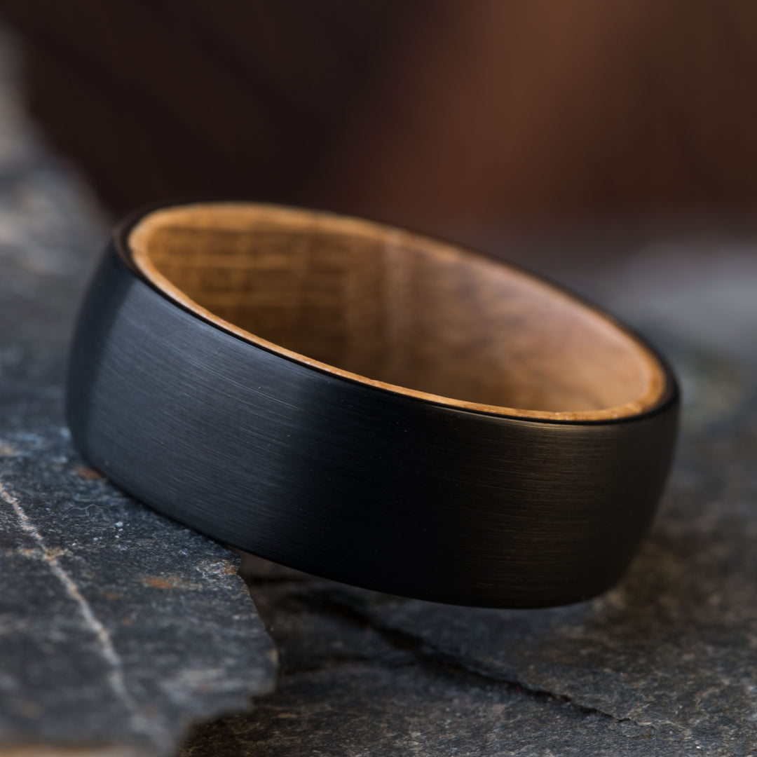 Black tungsten ring with whiskey barrel wood inlay