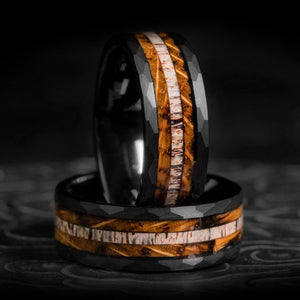 Two Dark Soul rings: black hammered tungsten, charred whisky barrel wood & antler inlays.