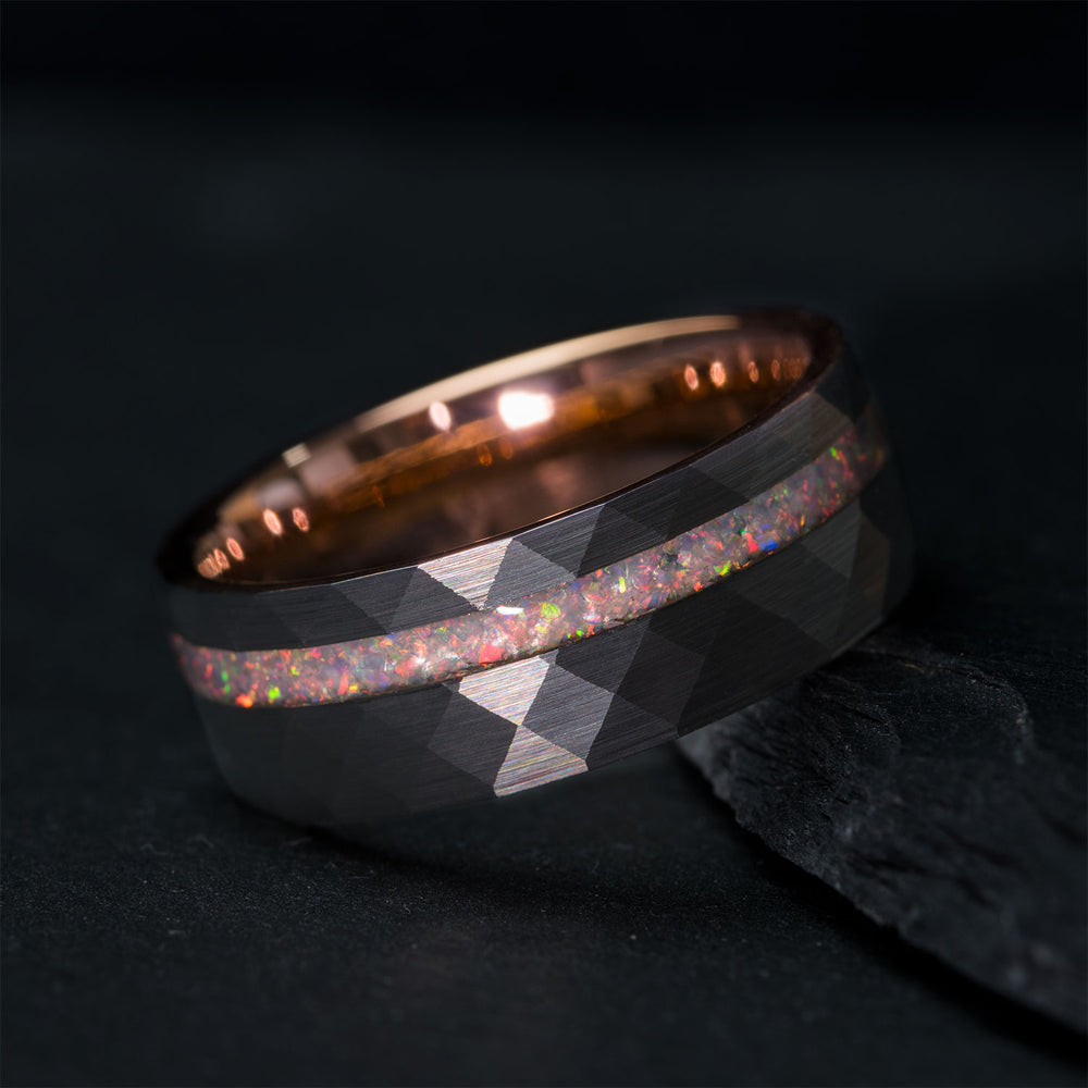 The Dawn ring: hammered tungsten band, rose gold interior, crushed opal inlay, faceted exterior.