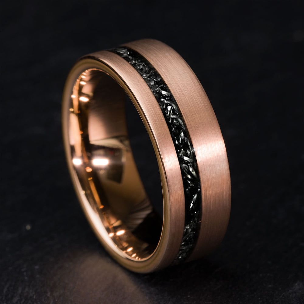 Rose gold tungsten carbide wedding band with Gibeon meteorite inlay detail.