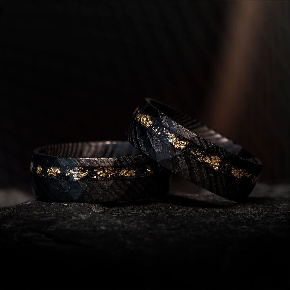 THE EXORCIST black hammered Damascus steel rings with gold leaf and Gibeon meteorite inlay. Product page.
