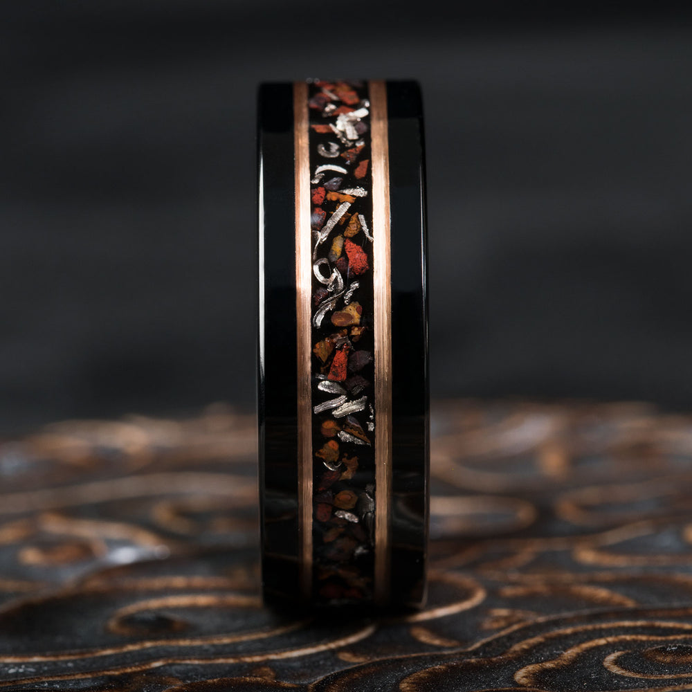 Black tungsten ring with dinosaur bone and meteorite inlay, rose gold trim.