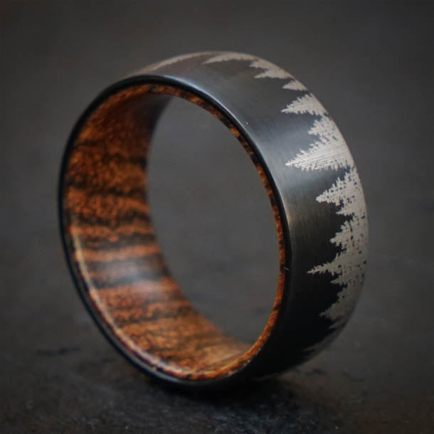 Black tungsten ring with forest design and olive wood sleeve