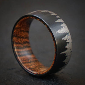 Black tungsten ring with forest design and olive wood sleeve
