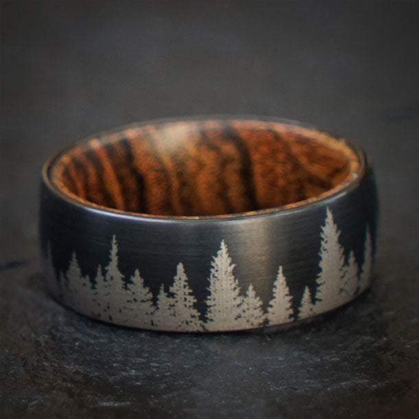 Black tungsten ring with forest silhouette and wood inlay