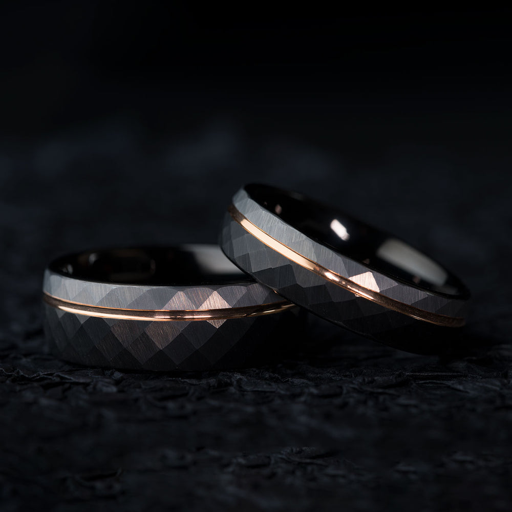 THE TROUBADOUR 6mm hammered tungsten wedding band with rose gold stripe and faceted texture.