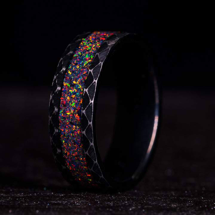 Black tungsten ring with fire opal inlay, hammered edge finish