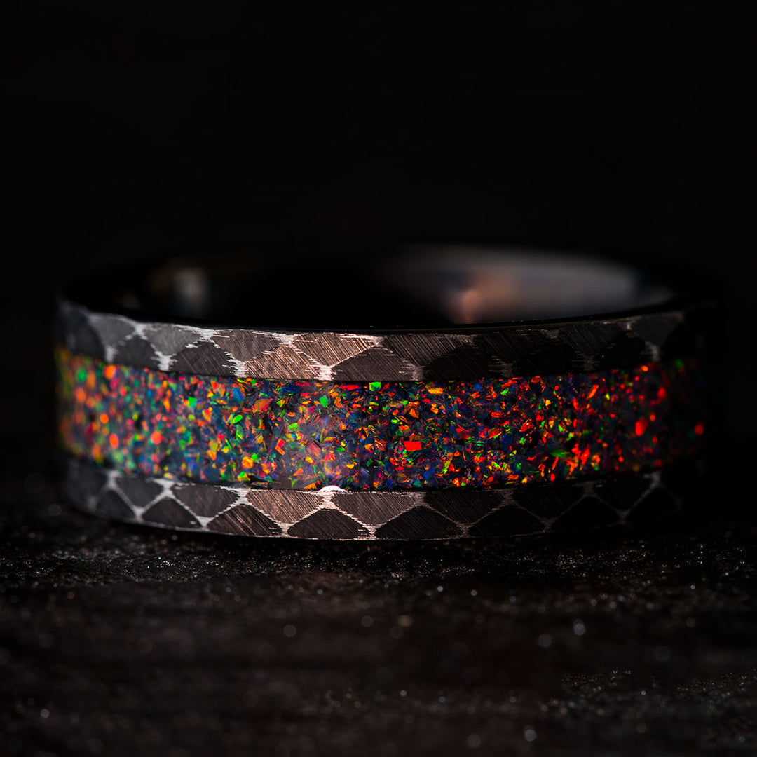 Black tungsten wedding band with fire opal inlay and hammered design
