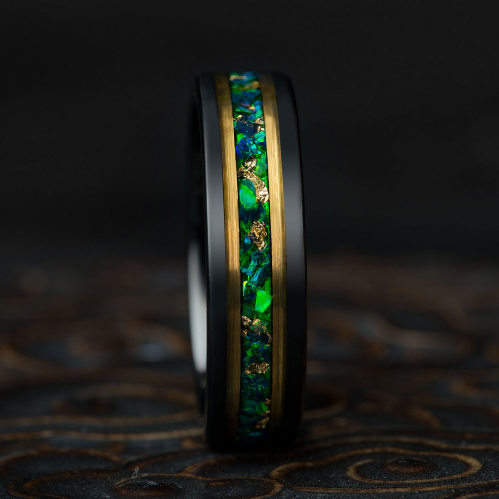 Black tungsten wedding band with vibrant green opal and 22k gold leaf inlay, product appearance showcase.