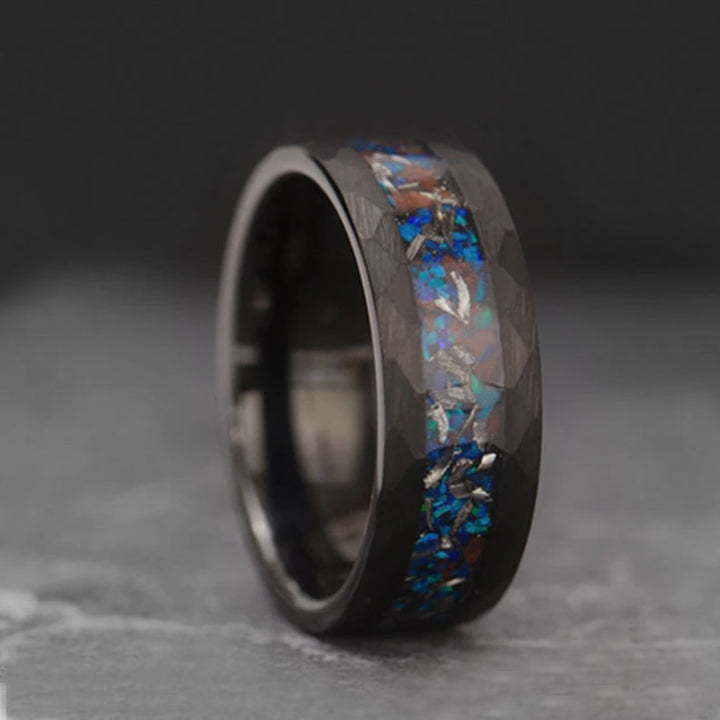 Close-up of The Magician ring: Black tungsten, opal, T-Rex bone, and meteorite.
