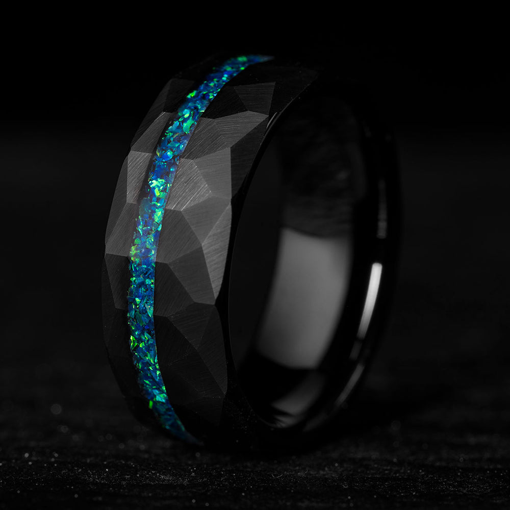 Black tungsten ring with faceted texture and vibrant blue-green opal inlay, 8mm wide wedding band.