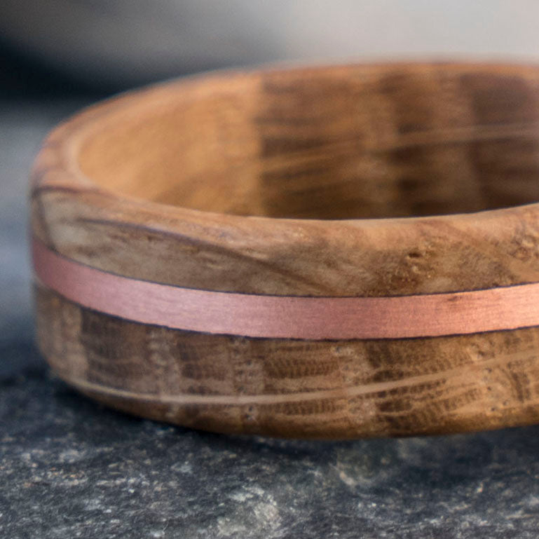 The Aficionado ring: whiskey barrel wood with rose gold copper inlay, 8mm wide, matte finish, product showcase.