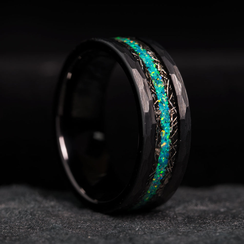 Black tungsten hammered ring with blue and green opal and meteorite inlay.