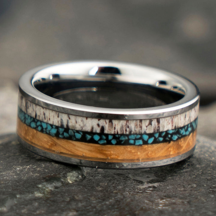 Men's tungsten ring with antler, turquoise, and whiskey barrel inlay detail