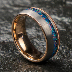 The Phantom men's tungsten wedding band with brushed silver exterior, rose gold interior, and multicolor opal inlay.