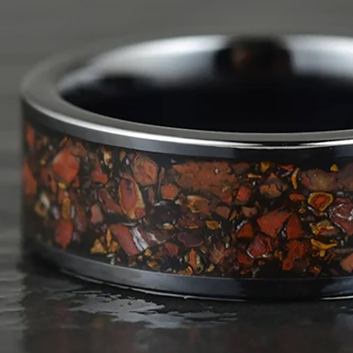 Close-up view of THE JURASSIC dinosaur bone ring, tungsten band with T. Rex fossil fragments.