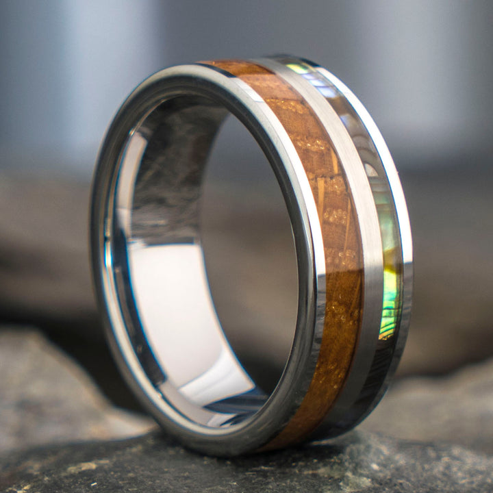 Close-up of THE MERCURY ring: tungsten, whiskey barrel wood, and abalone