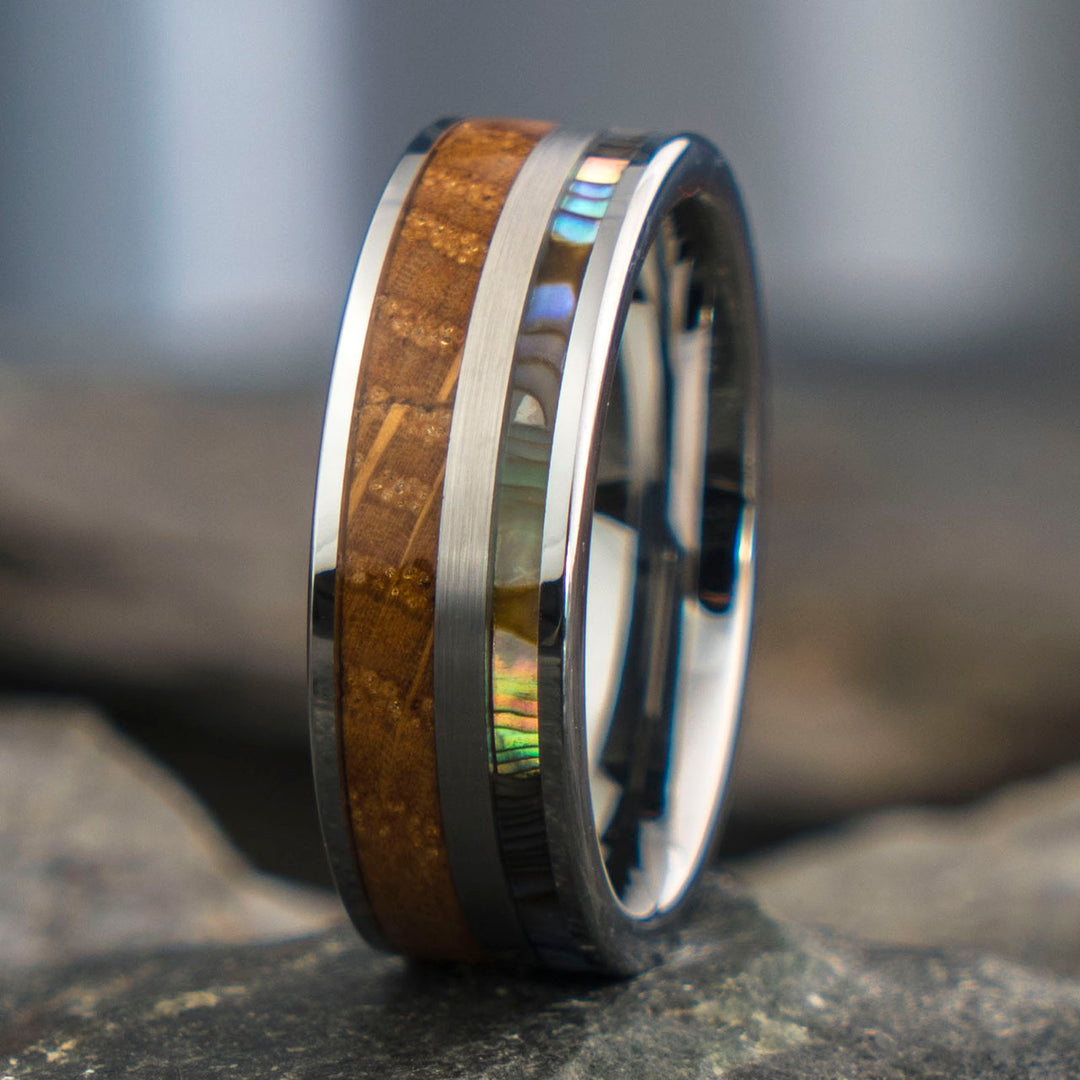 Close-up view of The Mercury ring with whiskey barrel wood and abalone inlay