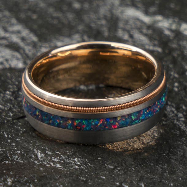 Men's tungsten ring, brushed silver exterior, rose gold interior, multicolor opal inlay with guitar string detail.
